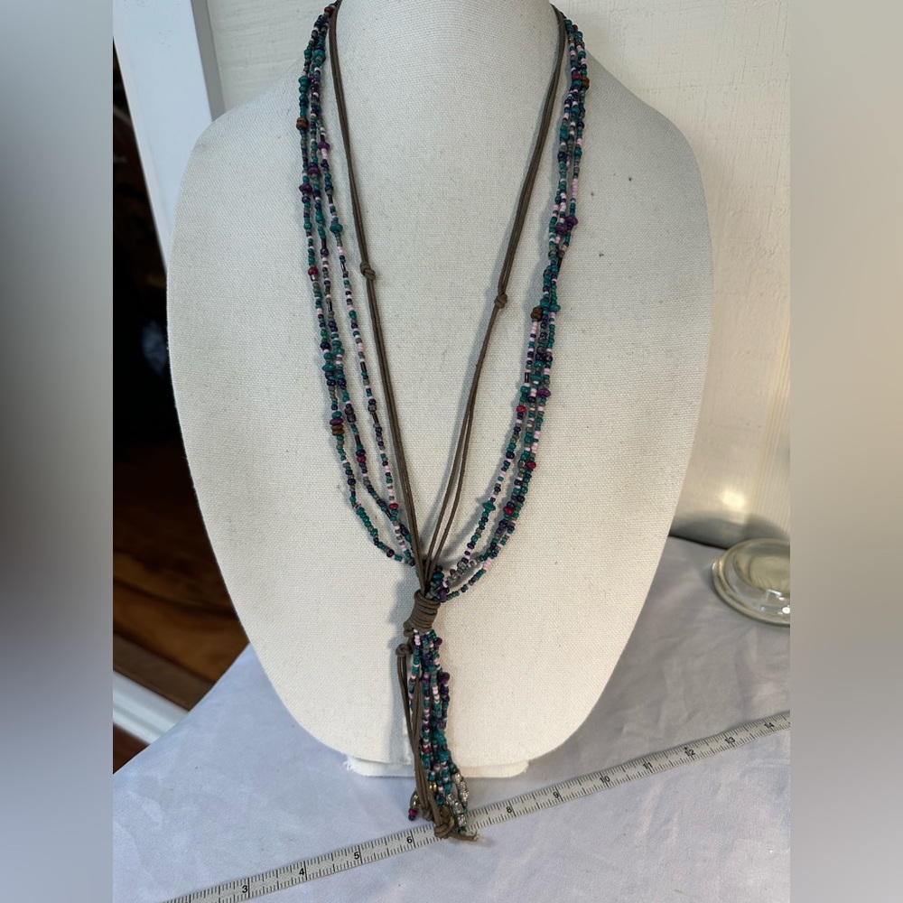 Long multi strand bead and leather cords necklace